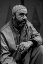Black and white portrait of a man wearing traditional Moroccan clothing, captured in Rabat.